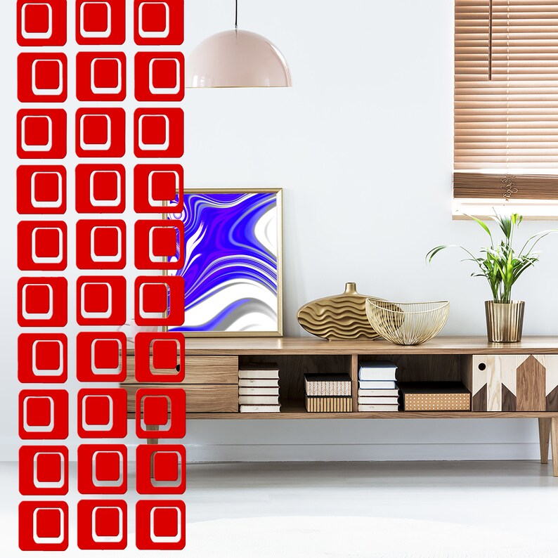May include: A wooden media console with six shelves, a gold metal decorative stand, a bowl, and a potted plant. The console is against a white wall with a light fixture hanging from the ceiling. The wall also features a red and white geometric pattern.