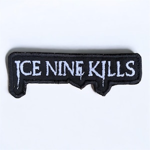 May include: A black embroidered patch featuring the text "ICE NINE KILLS" in white. The patch has a distinctive shape with irregular edges and a dripping effect on the letters, set against a white background.