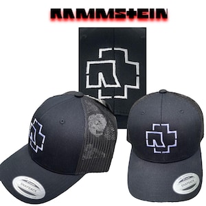 May include: Two black and white Rammstein trucker hats with a white logo of a cross with a stylized 'R' inside. The hats have a black mesh back and a black adjustable strap.