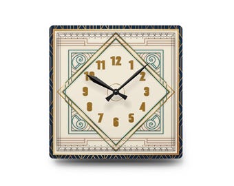 May include: A square wall clock featuring a cream-colored face with a central diamond shape containing gold-colored numerals from one to twelve. The clock has black hour and minute hands and is framed by a dark blue border with gold geometric lines.