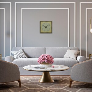 Clock displayed in a refined gray living room with white trim, round coffee table, and pink florals.