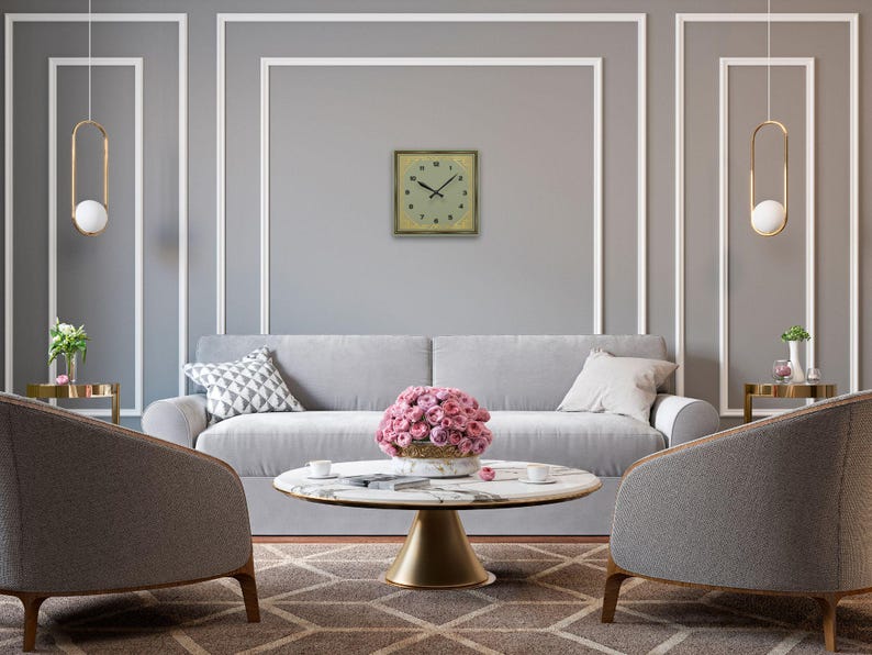 Clock displayed in a refined gray living room with white trim, round coffee table, and pink florals.