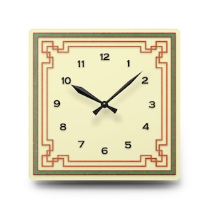 May include: Square wall clock with a cream-coloured face, black hands, and black numerals. The clock has a decorative border with red and green accents. The clock hands point to 10:10.