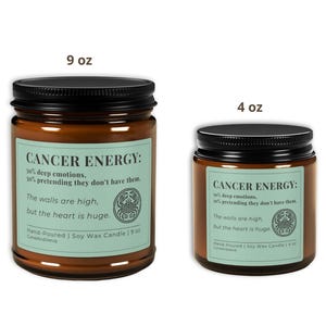 Cancer Zodiac Candle in 9 oz and 4 oz sizes with light green label. Hand-poured soy candles in amber glass jars, showcasing witty astrology humor for Cancer energy.