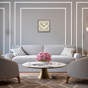 May include: A gray sofa with a floral centerpiece on a white marble coffee table in a living room with gray walls and gold pendant lights.