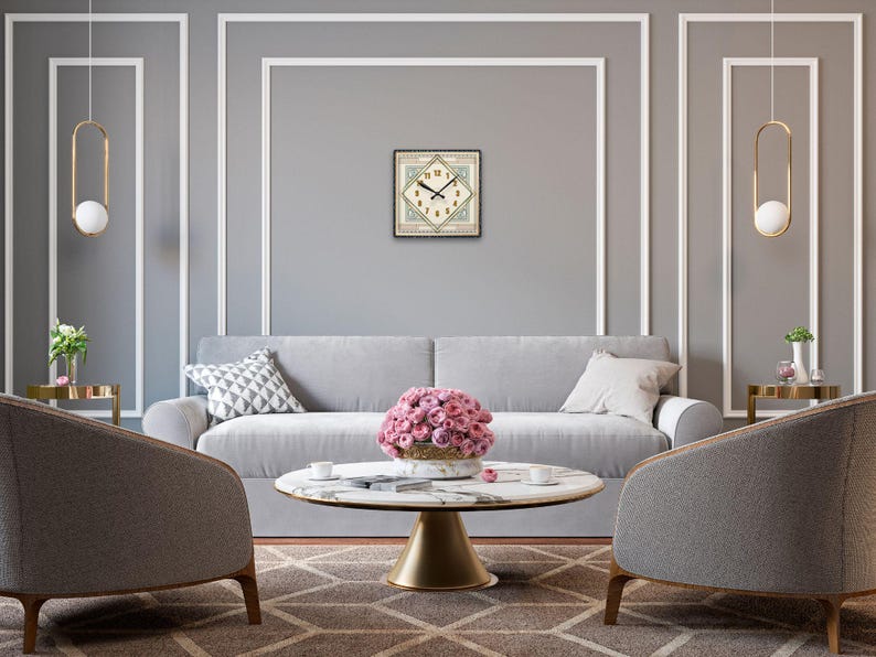 May include: A gray sofa with a floral centerpiece on a white marble coffee table in a living room with gray walls and gold pendant lights.