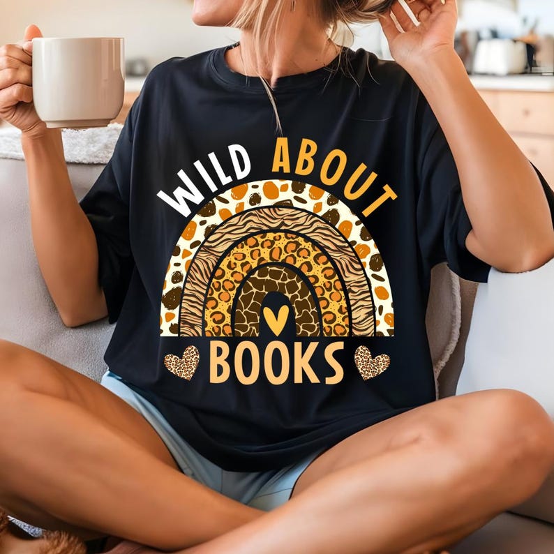 May include: Black t-shirt with a rainbow made of animal print patterns and the text "Wild About Books" with hearts on either side of the text.