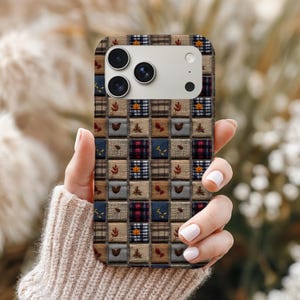 May include: A patterned phone case featuring a patchwork design with squares of plaid, burlap, and floral motifs in shades of brown, blue, and red. The case has a camera cutout and is held by a person.