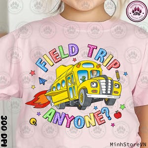May include: A pink t-shirt with a colorful graphic of a yellow school bus with the text "FIELD TRIP ANYONE?" in rainbow letters.