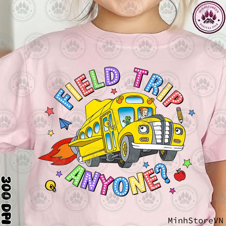 May include: A pink t-shirt featuring a colourful graphic of a yellow school bus with the text "FIELD TRIP ANYONE?" in rainbow letters.