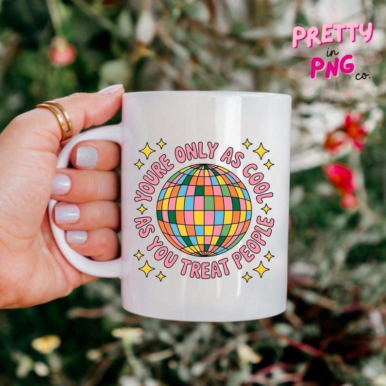 May include: White ceramic mug with a colorful disco ball graphic and the text "YOU'RE ONLY AS COOL AS YOU TREAT PEOPLE". The mug also has the text "PRETTY in PNG co." in the upper right corner.
