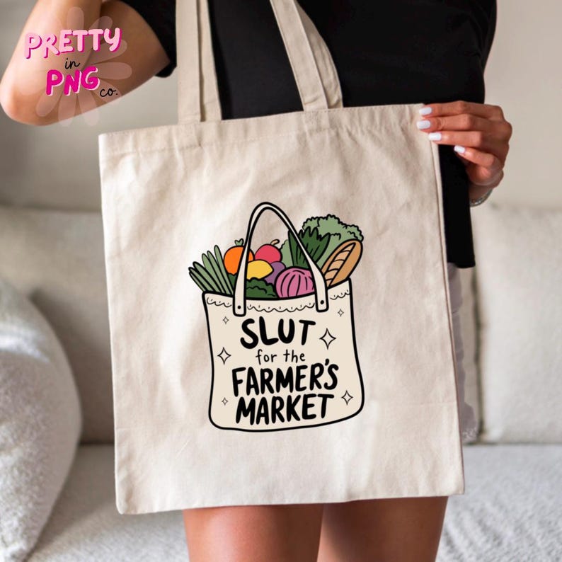 May include: A white canvas tote bag featuring a colourful illustration of a grocery bag filled with produce and the text "Slut for the Farmer's Market".