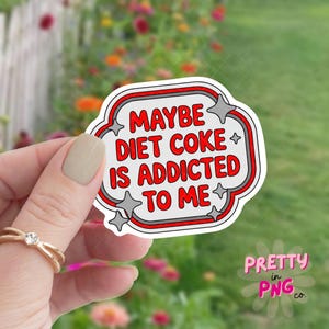 May include: A white sticker with a red and gray border, featuring the text "MAYBE DIET COKE IS ADDICTED TO ME" in red. The sticker has a unique shape with star accents and the words "Pretty in PNG co." in pink.