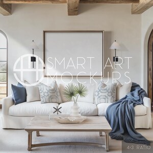 Beach House Art Display Mockup: This light-filled, blue-accented living space features a blank frame over a white linen sofa, for beach-themed or ocean-inspired art displays. Blank canvas frame on the wall ready for your artwork.