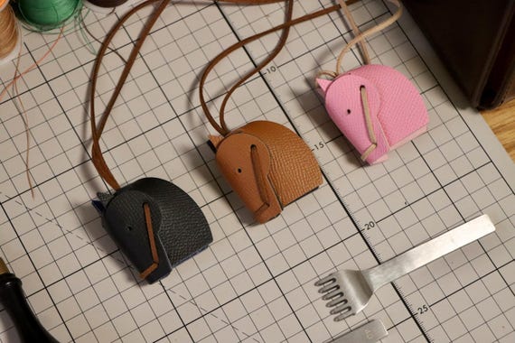 Hand-stitched full-grain leather keychain shaped like a horse, custom-stamped with a name — the kind of small craft detail that makes a horse person's eyes light up.