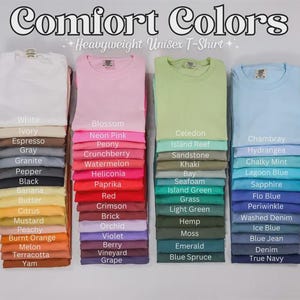 May include: Stacks of various colored Comfort Colors heavyweight unisex t-shirts. Colors include white, pink, green, and blue, with a wide range of shades like black, red, and yellow. The image also displays the names of each color.