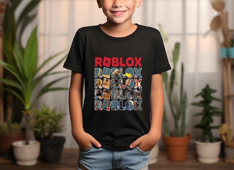 May include: Black t-shirt featuring the word "ROBLOX" in red and white block letters. Below, the word "ROBLOX" is repeated four times, each letter filled with different images. The shirt is worn by a child.