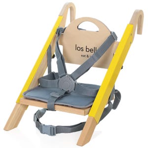 May include: A wooden high chair with a light wood finish and yellow accents. The chair features a gray seat and safety straps. The backrest has the text "los bell eat & i".