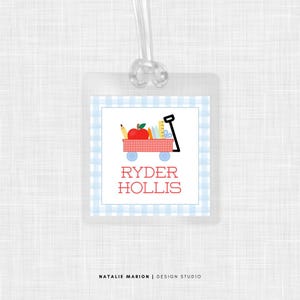 May include: Red and white gingham luggage tag with a red wagon filled with school supplies and the text "RYDER HOLLIS".