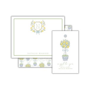 May include: Stationery set featuring a lemon tree design. The set includes a notepad with a lemon crest, a gift tag, and a patterned paper. The gift tag reads "a gift to you with love, Natalie Marion."
