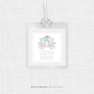 May include: A blue and gold carriage with a pink door and a crown on top. The text "Leighton Malone" is below the carriage.
