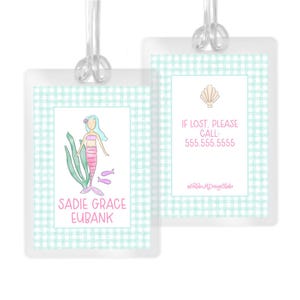 May include: Two rectangular luggage tags with a light green gingham border. One tag features a watercolor mermaid, green seaweed, and the name SADIE GRACE EUBANK. The other tag displays a seashell icon and the text IF LOST, PLEASE CALL 555.555.5555.