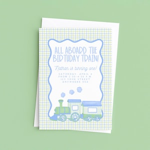 May include: A birthday invitation with a train illustration. The invitation has a blue and green plaid background with a blue scalloped border. The text reads "ALL ABOARD THE BIRTHDAY TRAIN!" and includes the name "Nathan", date, time, and address.