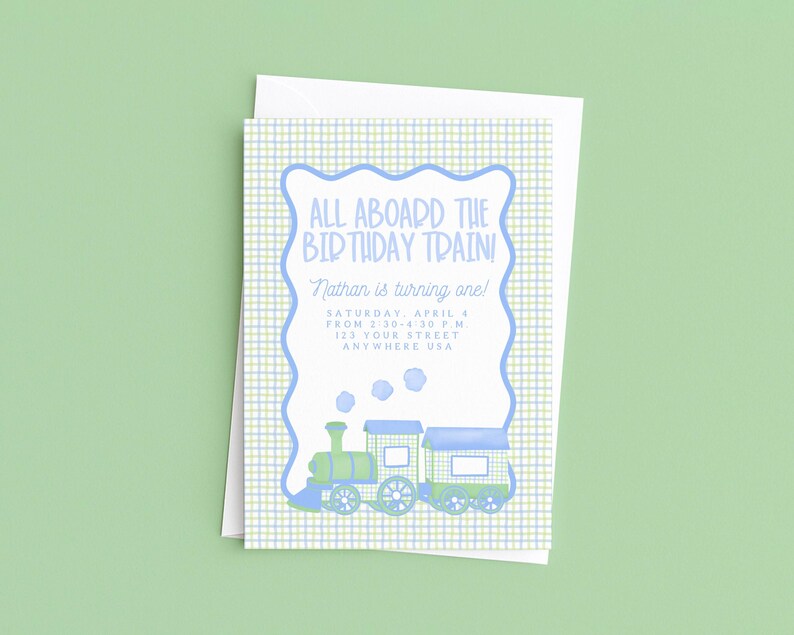 May include: A birthday invitation with a train illustration. The invitation has a blue and green plaid background with a blue scalloped border. The text reads "ALL ABOARD THE BIRTHDAY TRAIN!" and includes the name "Nathan", date, time, and address.