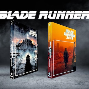 May include: Two Blu-ray cases featuring Blade Runner The Final Cut and Blade Runner 2049. The first case has a dark, rainy cityscape with a silhouette, while the second case displays an orange-toned desert landscape with a figure walking away.