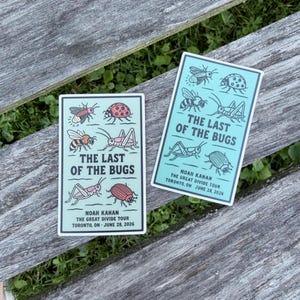 May include: Two rectangular stickers with a light blue background featuring various insect illustrations. The text reads THE LAST OF THE BUGS, NOAH KAHAN, THE GREAT DIVIDE TOUR, TORONTO, ON JUNE 28, 2026. The insects are drawn in black lines with red accents.
