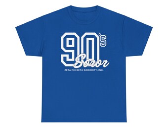 May include: A royal blue t-shirt with a white graphic of "90's Soror" in a vintage collegiate style font. The text "Zeta Phi Beta Sorority, Inc." is printed below the graphic.