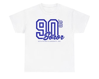 May include: White t-shirt with a blue graphic that says "90's Soror" and "Zeta Phi Beta Sorority, Inc."