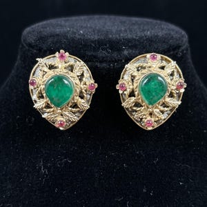 Vintage-inspired statement stud earrings with an antique gold finish, emerald-green cabochon center stones, ruby-red accents | Pretty Jewelr