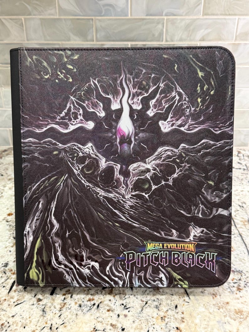 May include: A black rectangular binder featuring a dark, abstract graphic design with swirling white and purple patterns. The cover displays the text Mega Evolution Pitch Black in a stylized font with a rainbow-colored gradient border.