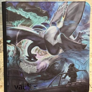 Peut inclure: Un classeur de cartes à collectionner rectangulaire avec une tranche noire et une couverture illustrée d'une créature ailée sombre volant dans un ciel orageux avec des éclairs. La silhouette d'une personne se tient sur un bateau au premier plan. Le mot vaultx est imprimé en noir dans le coin inférieur gauche.