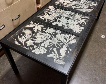 Black metal coffee table with four hand engraved glass panels of sea life