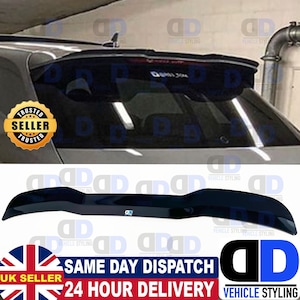 May include: Black rear spoiler for a car. The spoiler is made of a glossy black plastic and has a curved design. The spoiler is attached to the rear window of the car.