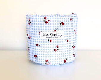 Gingham padded vanity bucket, blue soft storage basket, round cherry toiletry caddy, puffy bathroom makeup basket, fabric skincare organiser