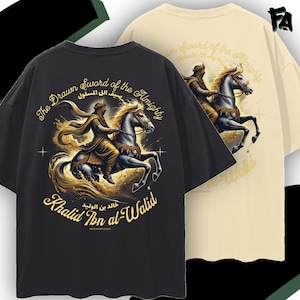 May include: A black and a cream-colored t-shirt featuring a graphic of a warrior on horseback. The text reads The Drawn Sword of the Almighty, Khalid Ibn al-Walid, and Arabic script. The design includes gold-toned accents and star symbols.