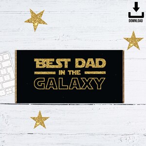May include: Black and gold mousepad with the text "Best Dad in the Galaxy" in a glittery font.