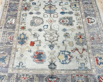 12599 – Handmade Oushak Rug 8x10 ft, Ivory Wool Area Rug with Gray Border, Red & Blue Accents, Traditional Floral Design