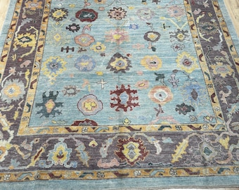 12578 – Handmade Oushak Rug 8x10 ft, Aqua Blue Wool Area Rug with Purple Border & Multicolor Tribal Floral Motifs