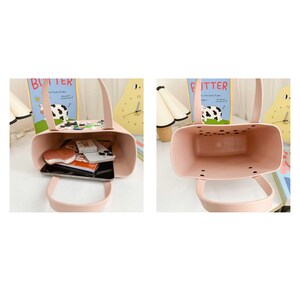 May include: A light pink tote bag with a rectangular shape and two handles. The bag is open, revealing a variety of items inside, including a phone, wallet, and notebook. A cow-themed decoration is attached to the top edge.