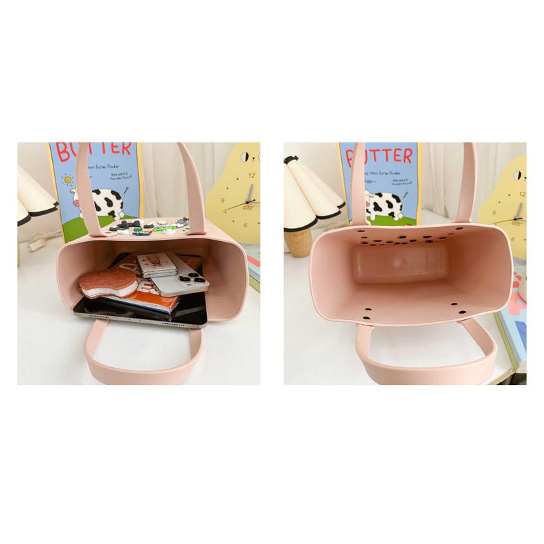 May include: A light pink tote bag with a rectangular shape and two handles. The bag is open, revealing a variety of items inside, including a phone, wallet, and notebook. A cow-themed decoration is attached to the top edge.
