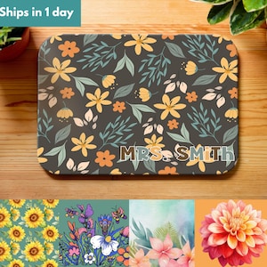 May include: Rectangular tray with a floral pattern in yellow, orange, and green on a dark gray background. The text "MRS. SMITH" is displayed in the lower right corner. Additional floral designs are shown below the tray.