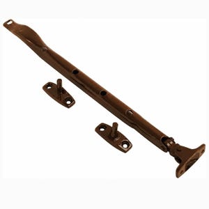 May include: A dark brown metal window casement stay bar featuring a series of circular adjustment holes along its length, accompanied by two separate mounting plates with vertical pins and a hinged bracket end piece for secure window attachment.