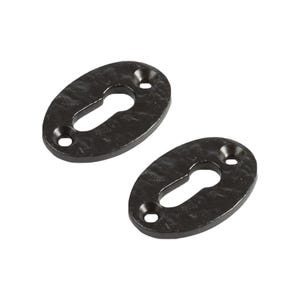 May include: Two oval-shaped black metal escutcheon plates for door locks. Each plate features a central keyhole cutout and two small circular screw holes at the top and bottom, with a textured, slightly uneven surface finish throughout.