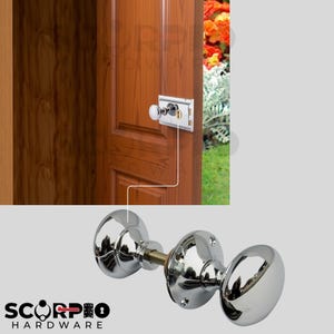 May include: A polished chrome door knob set featuring two spherical knobs connected by a threaded metal spindle and circular mounting plates with screw holes. The hardware is shown installed on a wooden door with a rectangular lock plate.