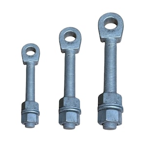May include: Three silver-colored metal eye bolts of varying lengths arranged vertically. Each bolt features a circular loop head, a long threaded shaft, and is equipped with a matching hexagonal nut and a flat washer at the base of the shaft.