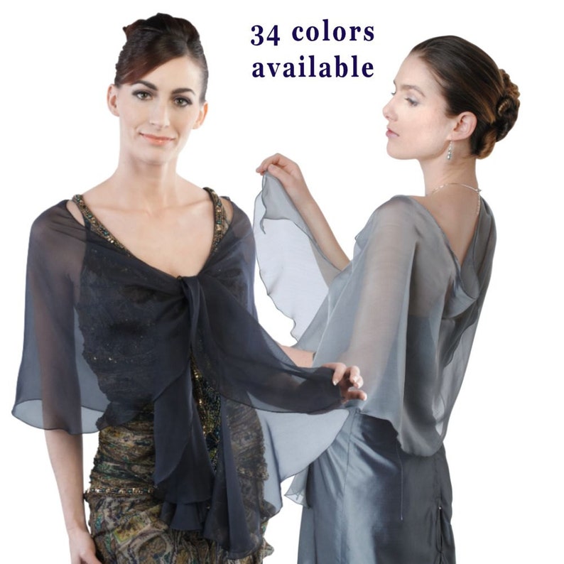 May include: Two women wearing sheer chiffon shawls in different colours. The shawls have a ruffled edge and are draped over the women's shoulders. The text "34 colours available" is displayed at the top of the image.